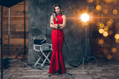 young-stylish-sexy-woman-cinema-backstage-celebrating-red-satin-evening-dress